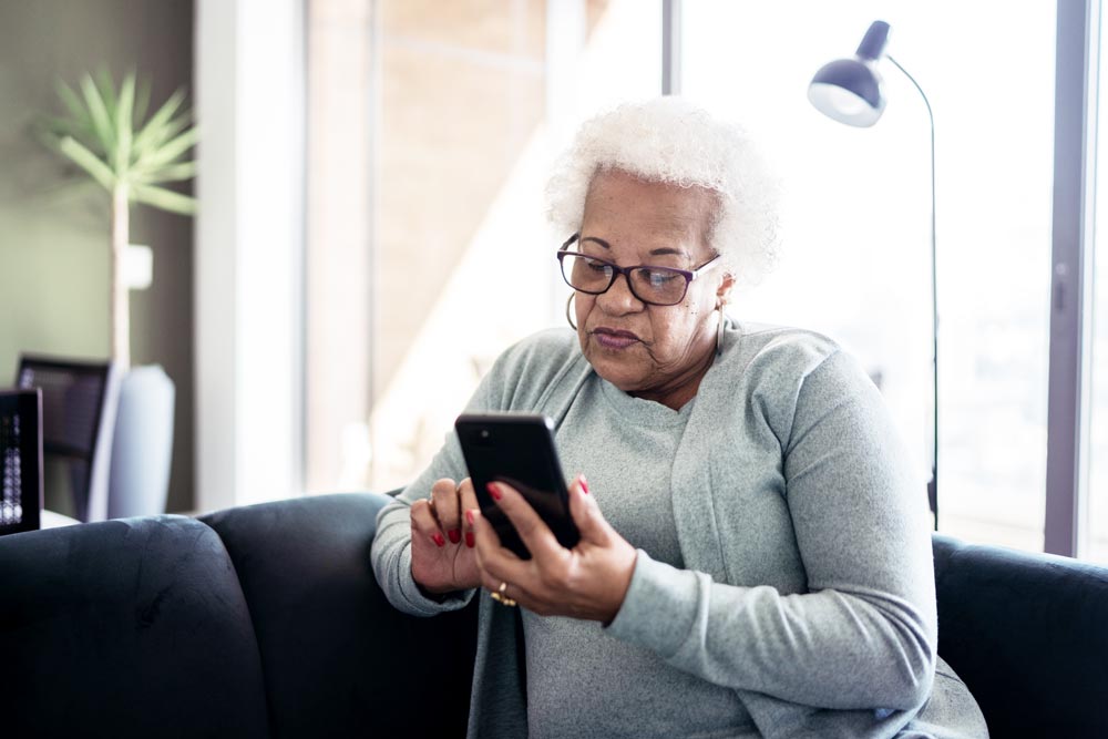 A woman using care navigator on her phone to find care